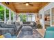 Cozy sunroom featuring a plush gray sectional sofa and lots of natural light at 14809 Senator Way, Carmel, IN 46032