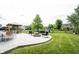 Large concrete patio showcasing a seating area, fire pit, and space to entertain on a well-maintained lawn at 16579 Lakeville Xing, Westfield, IN 46074