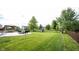 Well-manicured lawn leading to a concrete patio featuring a gazebo, fire pit, and play area at 16579 Lakeville Xing, Westfield, IN 46074