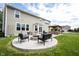 Inviting backyard patio with a fire pit, chairs, and basketball hoop, ideal for outdoor gatherings at 16579 Lakeville Xing, Westfield, IN 46074