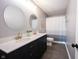 Modern bathroom featuring a double vanity, round mirrors and sleek fixtures at 16579 Lakeville Xing, Westfield, IN 46074