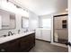 Modern bathroom featuring a double vanity sink, a laundry area, and a tiled walk-in shower at 16579 Lakeville Xing, Westfield, IN 46074
