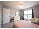 Bright bedroom with a dresser, a comfortable armchair, and a large window at 16579 Lakeville Xing, Westfield, IN 46074