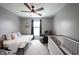 Bright bedroom features a ceiling fan, a comfortable armchair, and a crib for a Bedroom at 16579 Lakeville Xing, Westfield, IN 46074