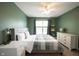 This bedroom features ample space with a ceiling fan and natural light from a window at 16579 Lakeville Xing, Westfield, IN 46074