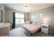 Cozy bedroom features a comfortable bed, a plush armchair, and charming decor at 16579 Lakeville Xing, Westfield, IN 46074