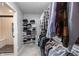 Organized walk-in closet with shelving and ample hanging space, leading to a stylish shower at 16579 Lakeville Xing, Westfield, IN 46074