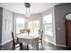 Cozy dining area with pendant lighting and abundant natural light from surrounding windows at 16579 Lakeville Xing, Westfield, IN 46074