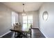Dining room with dark wood floors and modern chandelier at 16579 Lakeville Xing, Westfield, IN 46074