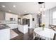 View of open-concept kitchen with island, stainless steel appliances, and breakfast nook dining area at 16579 Lakeville Xing, Westfield, IN 46074