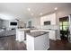 Open-concept kitchen with an island, stainless steel appliances, and view to the living room at 16579 Lakeville Xing, Westfield, IN 46074