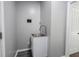 A laundry area with modern stainless steel sink and light grey paint at 16579 Lakeville Xing, Westfield, IN 46074