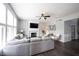 Bright living room with large windows, ceiling fan, fireplace, and comfortable gray sectional sofa at 16579 Lakeville Xing, Westfield, IN 46074