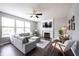 Cozy living room with a fireplace, large windows, and contemporary furnishings, creating a comfortable ambiance at 16579 Lakeville Xing, Westfield, IN 46074