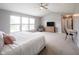 Spacious main bedroom with neutral walls, a ceiling fan, and a view of the en-suite bathroom at 16579 Lakeville Xing, Westfield, IN 46074