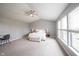 Spacious main bedroom featuring neutral walls, vaulted ceilings, large windows, and a ceiling fan at 16579 Lakeville Xing, Westfield, IN 46074