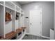 Charming mudroom featuring a custom storage unit with seating and hooks at 16579 Lakeville Xing, Westfield, IN 46074
