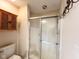 A neutral bathroom has a glass-enclosed shower, a wooden cabinet, and modern fixtures at 16657 Brownstone Ct, Westfield, IN 46074