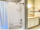 A bathroom features a tub with a shower and a granite vanity with modern fixtures at 16657 Brownstone Ct, Westfield, IN 46074