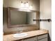 A neutral bathroom has granite countertops, a decorative mirror, and ample storage space at 16657 Brownstone Ct, Westfield, IN 46074