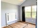A light blue bedroom features a large window with curtains and a white headboard and frame at 16657 Brownstone Ct, Westfield, IN 46074