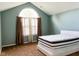 A bright bedroom features a large arch window with neutral curtains and a comfortable bed at 16657 Brownstone Ct, Westfield, IN 46074