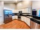 A modern kitchen features stainless steel appliances, granite countertops, and white cabinetry for ample storage at 16657 Brownstone Ct, Westfield, IN 46074