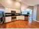 Modern kitchen with stainless steel appliances, white cabinets, and hardwood flooring at 16657 Brownstone Ct, Westfield, IN 46074