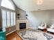 Spacious living room featuring a fireplace, vaulted ceilings, a large window, and chandelier at 16657 Brownstone Ct, Westfield, IN 46074