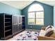 Bright living room with vaulted ceilings, large window, built-in storage, and a cozy seating area at 16657 Brownstone Ct, Westfield, IN 46074