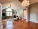 Open-concept living room with hardwood floors, fireplace, and abundant natural light from vaulted window at 16657 Brownstone Ct, Westfield, IN 46074