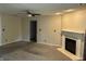 Open living room featuring neutral paint, plush carpet, a fireplace, and a ceiling fan at 1716 W Witt Ave, Lebanon, IN 46052