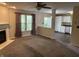 Inviting living room featuring a cozy fireplace, large windows, and seamless flow into an adjacent kitchen area at 1716 W Witt Ave, Lebanon, IN 46052