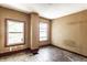 Bedroom featuring natural light from two windows and original hardwood floors ready to be refinished at 2114 Sugar Grove Ave, Indianapolis, IN 46202