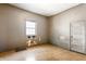 A bedroom featuring a window, door, and wooden floors at 2114 Sugar Grove Ave, Indianapolis, IN 46202