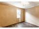 Bedroom with one window, textured walls, and bare floors at 2114 Sugar Grove Ave, Indianapolis, IN 46202