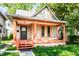 Charming home featuring a covered porch with orange columns and freshly painted trim accents at 2114 Sugar Grove Ave, Indianapolis, IN 46202