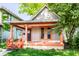 Charming home featuring a covered porch with orange columns and freshly painted trim accents at 2114 Sugar Grove Ave, Indianapolis, IN 46202