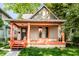 Charming home featuring a covered porch with orange columns and freshly painted trim accents at 2114 Sugar Grove Ave, Indianapolis, IN 46202