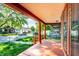 Inviting covered front porch with orange painted floor and columns, perfect for outdoor relaxation at 2114 Sugar Grove Ave, Indianapolis, IN 46202