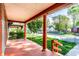 Inviting covered front porch with orange painted floor and columns, perfect for outdoor relaxation at 2114 Sugar Grove Ave, Indianapolis, IN 46202