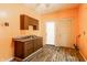 This is a kitchen featuring orange walls with dark cabinets and light floor at 2114 Sugar Grove Ave, Indianapolis, IN 46202