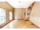 Open living room with wood floors, offering ample space and natural light from large windows at 2114 Sugar Grove Ave, Indianapolis, IN 46202