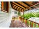 A covered porch features wood flooring and railings at 2114 Sugar Grove Ave, Indianapolis, IN 46202