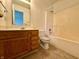 Standard bathroom with wood vanity, a toilet, and a shower-tub combo at 212 Woodberry Dr, Danville, IN 46122