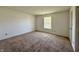 Cozy bedroom with carpet flooring, a window, and neutral wall paint at 212 Woodberry Dr, Danville, IN 46122