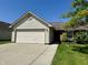 Charming single-story home with a well-maintained lawn and attached two-car garage at 212 Woodberry Dr, Danville, IN 46122