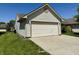 Attached two-car garage featuring classic paneled doors, matching siding, and convenient driveway access at 212 Woodberry Dr, Danville, IN 46122
