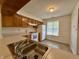 Well-lit kitchen with wood cabinets, white appliances, and a bright window view at 212 Woodberry Dr, Danville, IN 46122