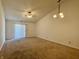 Bright living room with carpet flooring, ceiling fan and sliding glass doors at 212 Woodberry Dr, Danville, IN 46122